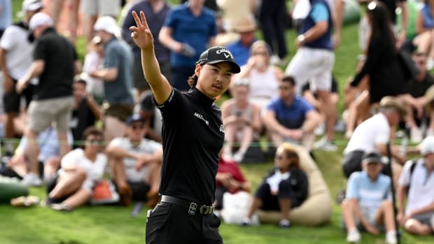 Min Woo Lee gestures to fans at the 2023 Australian Open.